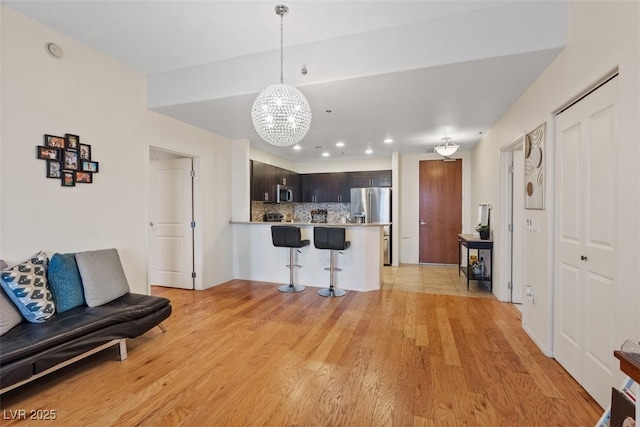 8255 Las Vegas Blvd Unit 1905, Las Vegas, NV 89123 - living room with a chandelier, light wood finished floors, and recessed lighting