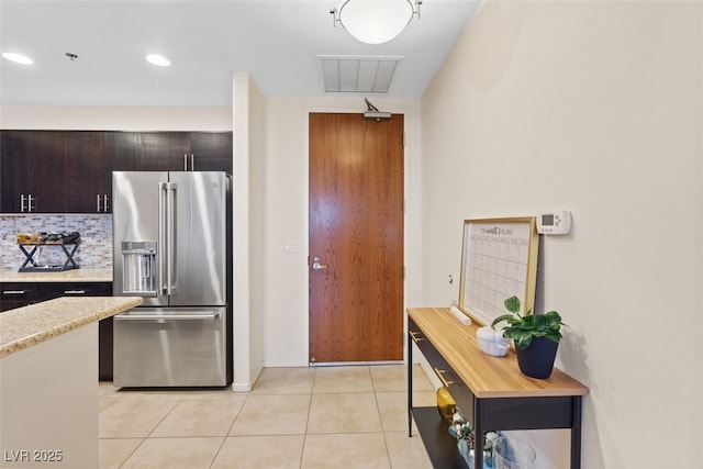 8255 Las Vegas Blvd Unit 1905, Las Vegas, NV 89123 - kitchen with high end refrigerator, light countertops, backsplash, light tile patterned floors, and recessed lighting