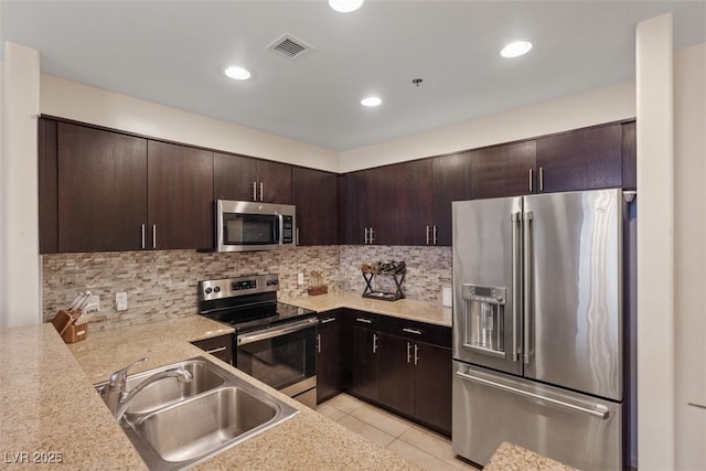 8255 Las Vegas Blvd Unit 1905, Las Vegas, NV 89123 - kitchen with stainless steel appliances, dark brown cabinets, light countertops, backsplash, and recessed lighting