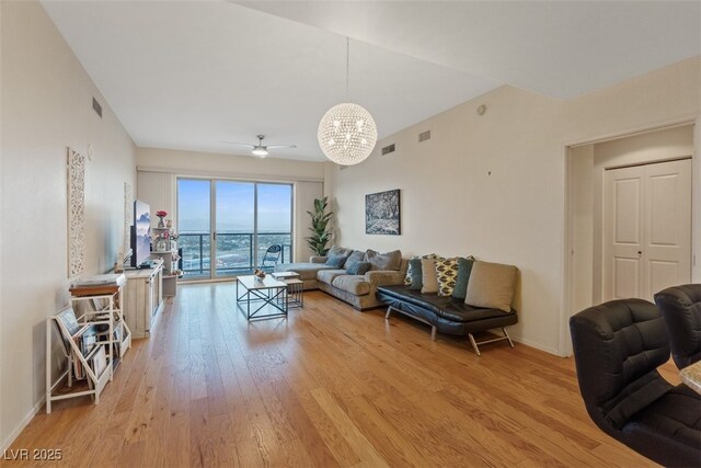 8255 Las Vegas Blvd Unit 1905, Las Vegas, NV 89123 - living room with light wood-style floors, a chandelier, and a ceiling fan