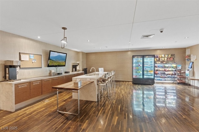 8255 Las Vegas Blvd Unit 1905, Las Vegas, NV 89123 - kitchen featuring hardwood / wood-style flooring, brown cabinetry, light countertops, modern cabinets, and a center island with sink