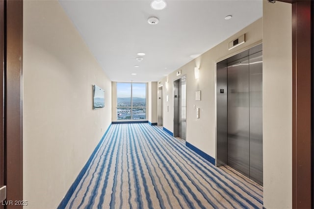8255 Las Vegas Blvd Unit 1905, Las Vegas, NV 89123 - hallway featuring elevator, carpet flooring, floor to ceiling windows, and recessed lighting