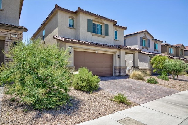 835 Aurelie Ridge St, Henderson, NV 89011 - mediterranean / spanish home featuring stucco siding, a garage, a tiled roof, driveway, and stone siding