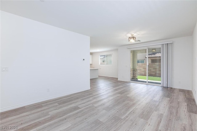 835 Aurelie Ridge St, Henderson, NV 89011 - unfurnished living room with light wood-style flooring and baseboards
