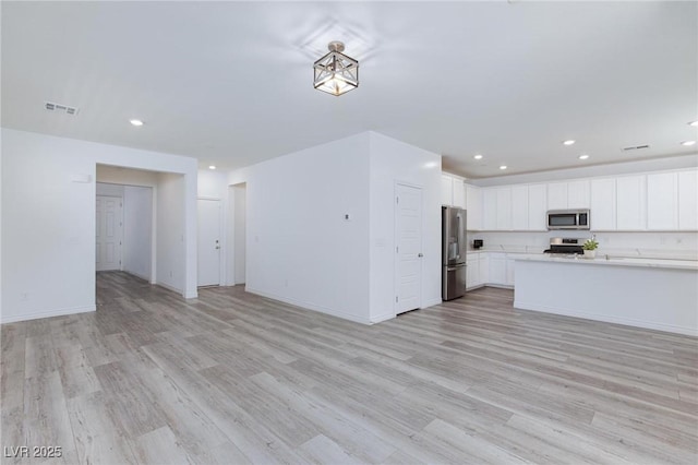 835 Aurelie Ridge St, Henderson, NV 89011 - kitchen featuring appliances with stainless steel finishes, open floor plan, light countertops, light wood-style flooring, and recessed lighting