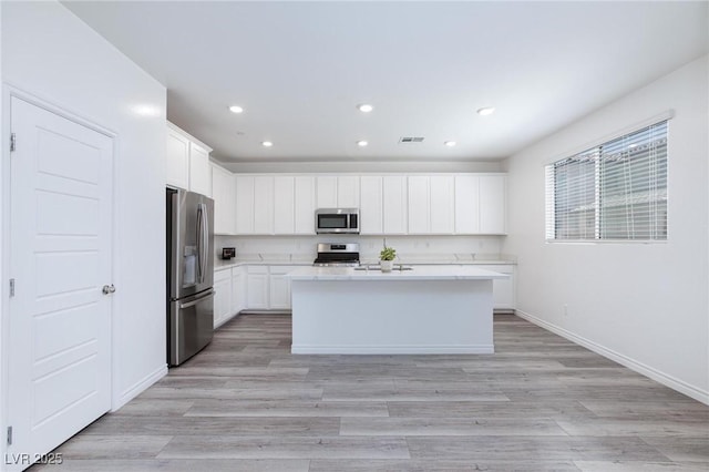 835 Aurelie Ridge St, Henderson, NV 89011 - kitchen featuring stainless steel appliances, recessed lighting, light countertops, white cabinets, and light wood-style flooring