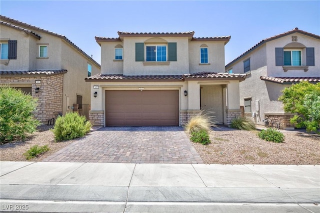 835 Aurelie Ridge St, Henderson, NV 89011 - mediterranean / spanish-style home featuring stucco siding, driveway, a garage, and stone siding