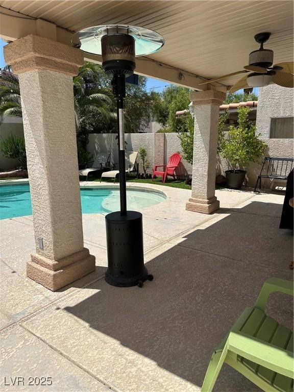 10265 Moth Orchid Ct, Las Vegas, NV 89183 - view of swimming pool featuring a ceiling fan, a patio, and a fenced backyard