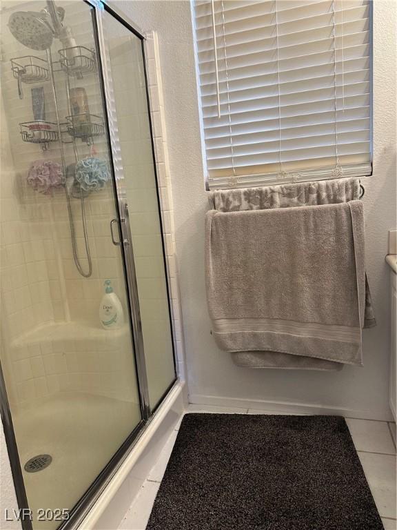 10265 Moth Orchid Ct, Las Vegas, NV 89183 - bathroom featuring tile patterned floors and a shower stall