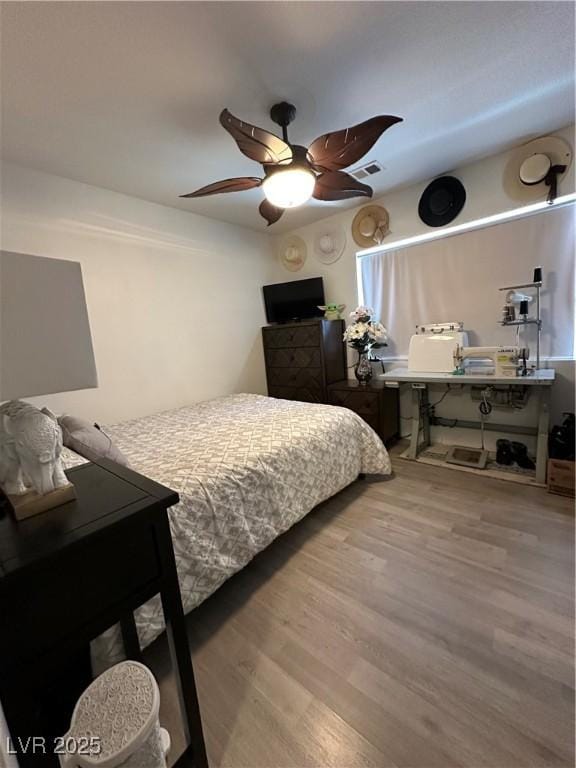10265 Moth Orchid Ct, Las Vegas, NV 89183 - bedroom featuring wood finished floors and a ceiling fan