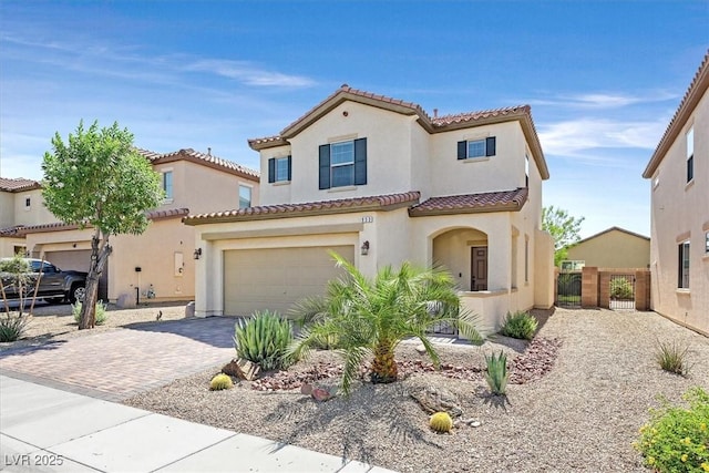 953 Via Del Tramonto St, Henderson, NV 89011 - mediterranean / spanish-style home featuring a tile roof, stucco siding, and driveway