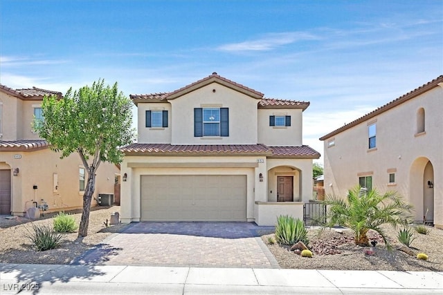 953 Via Del Tramonto St, Henderson, NV 89011 - mediterranean / spanish-style house featuring stucco siding, a garage, decorative driveway, and a tiled roof
