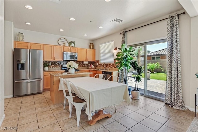 953 Via Del Tramonto St, Henderson, NV 89011 - kitchen featuring stainless steel appliances, decorative backsplash, a kitchen island, light brown cabinets, and recessed lighting