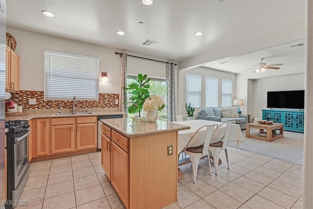953 Via Del Tramonto St, Henderson, NV 89011 - kitchen with stainless steel appliances, light brown cabinetry, light tile patterned floors, a breakfast bar area, and recessed lighting