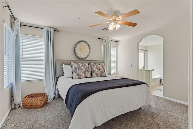953 Via Del Tramonto St, Henderson, NV 89011 - carpeted bedroom with arched walkways, a ceiling fan, and connected bathroom