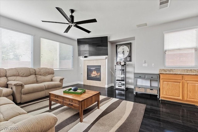 10300 S Dapple Gray Rd, Las Vegas, NV 89178 - living room with ceiling fan, dark wood-style flooring, a fireplace, and healthy amount of natural light