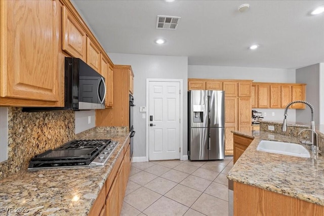 10300 S Dapple Gray Rd, Las Vegas, NV 89178 - kitchen with stainless steel appliances, light tile patterned flooring, light stone counters, backsplash, and recessed lighting