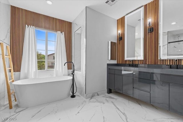 10300 S Dapple Gray Rd, Las Vegas, NV 89178 - full bathroom featuring a soaking tub, vanity, marble finish floors, and recessed lighting