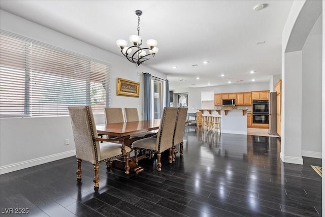 10300 S Dapple Gray Rd, Las Vegas, NV 89178 - dining room with a chandelier, wood finished floors, recessed lighting, and arched walkways