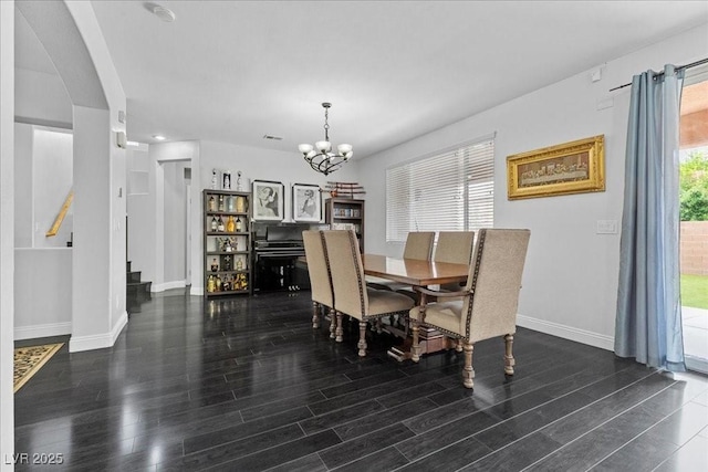 10300 S Dapple Gray Rd, Las Vegas, NV 89178 - dining room featuring wood finished floors, a chandelier, arched walkways, and stairway