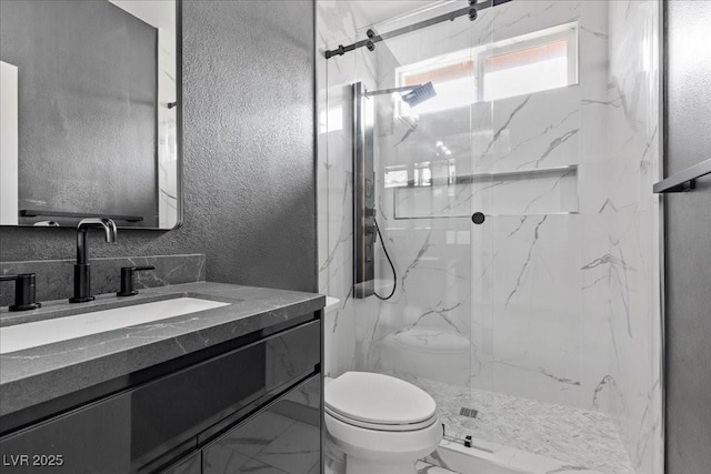 10300 S Dapple Gray Rd, Las Vegas, NV 89178 - bathroom featuring marble look tiles, a marble finish shower, vanity, and a textured wall