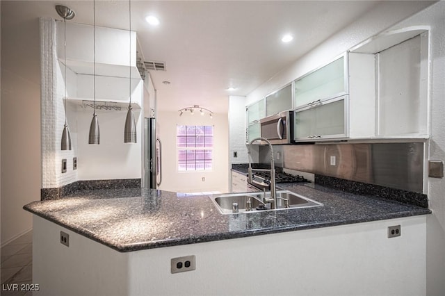 10414 Midseason Mist St, Las Vegas, NV 89183 - kitchen with appliances with stainless steel finishes, a peninsula, open shelves, glass insert cabinets, and recessed lighting