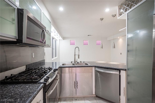 10414 Midseason Mist St, Las Vegas, NV 89183 - kitchen featuring appliances with stainless steel finishes, a peninsula, dark stone countertops, recessed lighting, and light tile patterned flooring