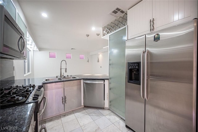 10414 Midseason Mist St, Las Vegas, NV 89183 - kitchen with appliances with stainless steel finishes, dark stone countertops, light marble finish flooring, and recessed lighting