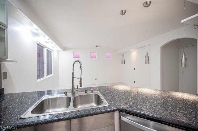 10414 Midseason Mist St, Las Vegas, NV 89183 - kitchen featuring dishwasher, dark stone countertops, arched walkways, and glass insert cabinets