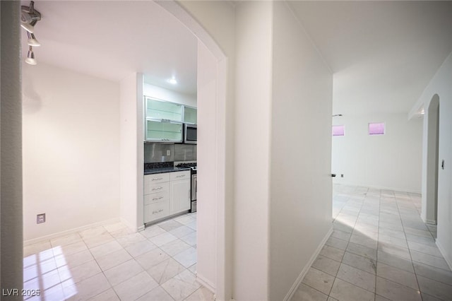 10414 Midseason Mist St, Las Vegas, NV 89183 - corridor featuring light tile patterned floors and arched walkways