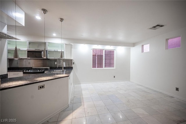 10414 Midseason Mist St, Las Vegas, NV 89183 - kitchen with stainless steel microwave, stove, decorative backsplash, and recessed lighting
