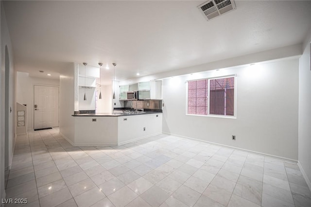 10414 Midseason Mist St, Las Vegas, NV 89183 - kitchen featuring dark countertops, white cabinetry, stainless steel microwave, open shelves, and a peninsula