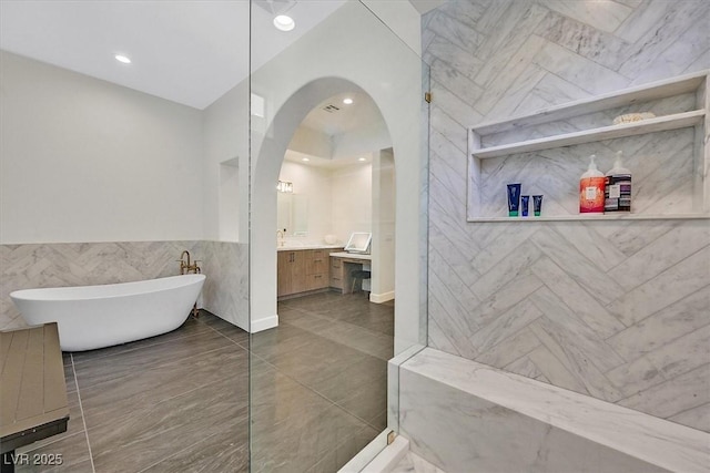 11906 Port Labelle Dr, Las Vegas, NV 89141 - bathroom featuring a freestanding bath, vanity, tile walls, recessed lighting, and a shower
