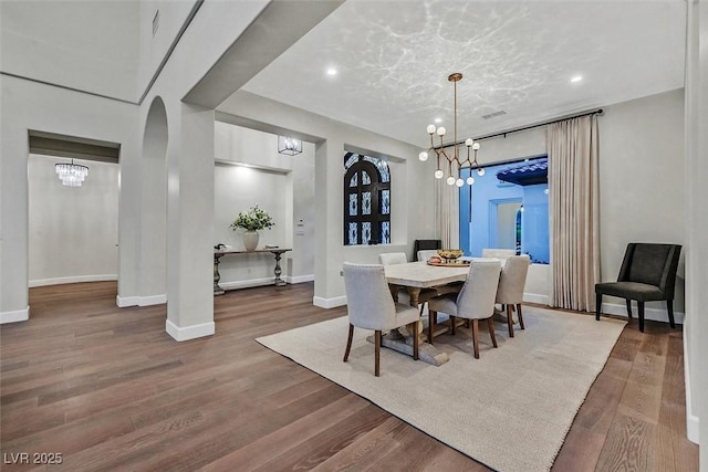 11906 Port Labelle Dr, Las Vegas, NV 89141 - dining area featuring a chandelier, wood finished floors, recessed lighting, and arched walkways
