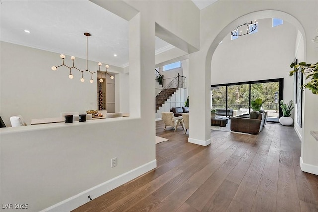 11906 Port Labelle Dr, Las Vegas, NV 89141 - foyer entrance featuring a chandelier, hardwood / wood-style floors, arched walkways, stairway, and recessed lighting