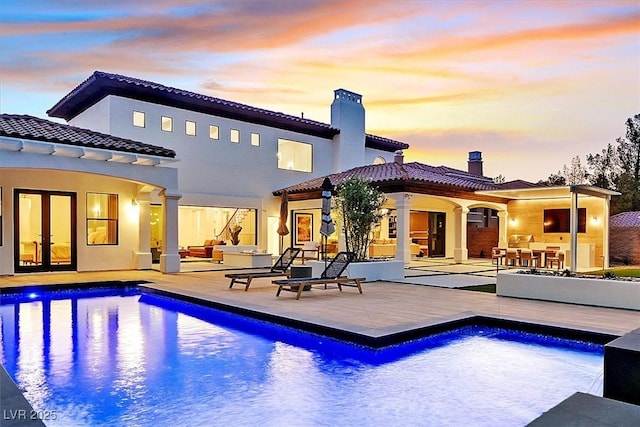 11906 Port Labelle Dr, Las Vegas, NV 89141 - back of property with a chimney, a tile roof, a patio, an outdoor pool, and french doors