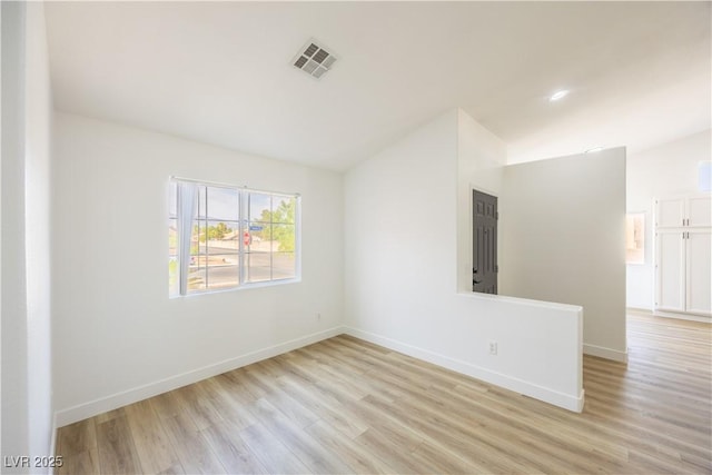 2403 Sexton Ave, North Las Vegas, NV 89031 - spare room with vaulted ceiling and light wood-style floors