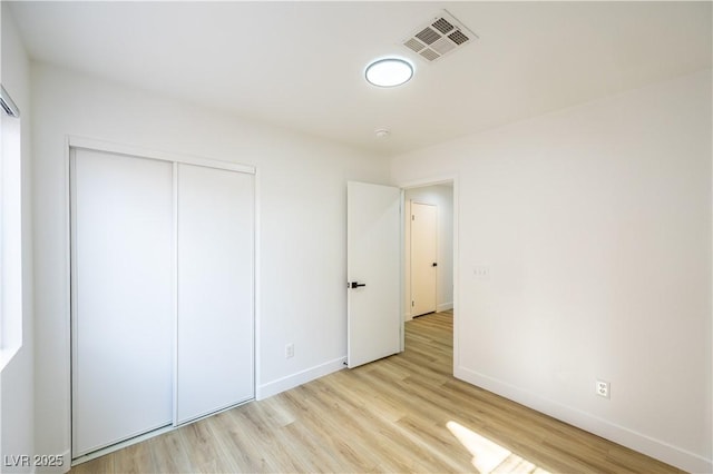 2403 Sexton Ave, North Las Vegas, NV 89031 - unfurnished bedroom with light wood finished floors and a closet