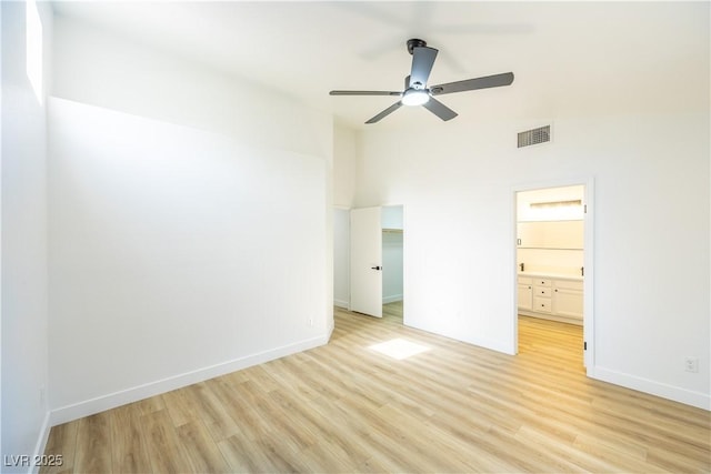 2403 Sexton Ave, North Las Vegas, NV 89031 - unfurnished bedroom featuring light wood finished floors, connected bathroom, a walk in closet, and ceiling fan