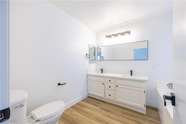 2403 Sexton Ave, North Las Vegas, NV 89031 - bathroom featuring wood finished floors, double vanity, and a bath