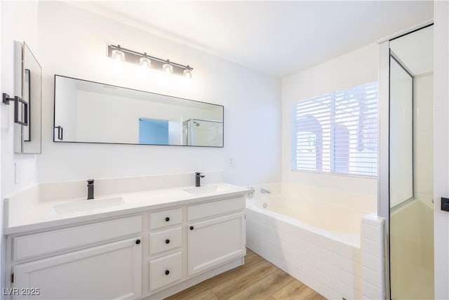 2403 Sexton Ave, North Las Vegas, NV 89031 - full bath with a garden tub, double vanity, wood finished floors, and a shower with door