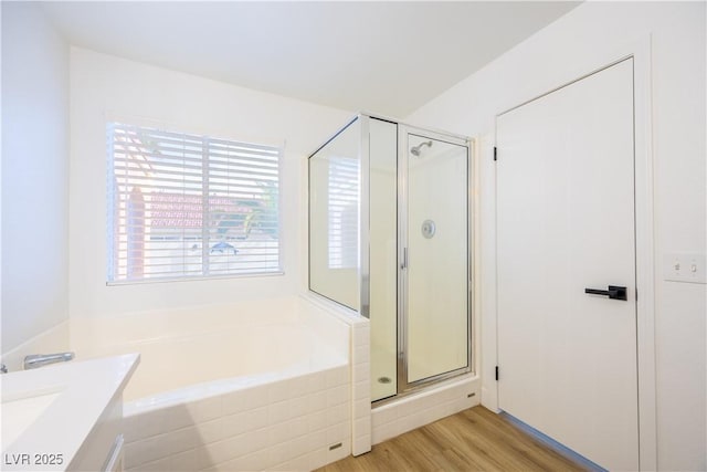 2403 Sexton Ave, North Las Vegas, NV 89031 - full bath with a garden tub, a shower stall, wood finished floors, and vanity