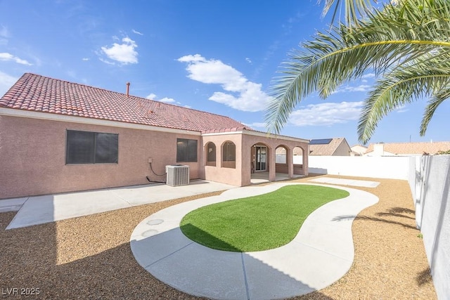 2403 Sexton Ave, North Las Vegas, NV 89031 - rear view of house featuring a tiled roof, stucco siding, a fenced backyard, and a patio