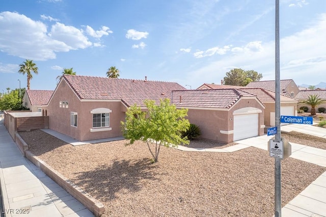 2403 Sexton Ave, North Las Vegas, NV 89031 - view of front of home featuring stucco siding, driveway, a tiled roof, and an attached garage