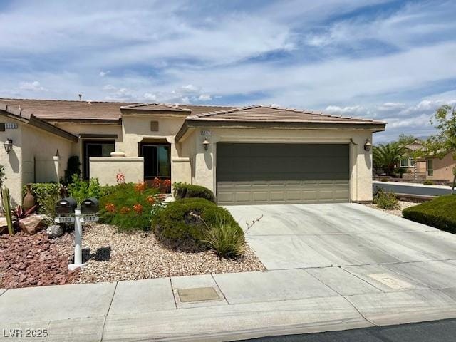 5147 Progresso St, Las Vegas, NV 89135 - prairie-style house featuring concrete driveway, a garage, and stucco siding