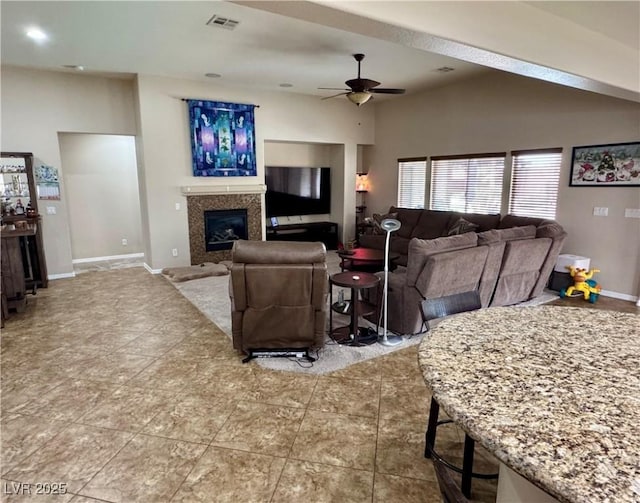6614 Collingsworth St, Las Vegas, NV 89131 - living room featuring a ceiling fan, a glass covered fireplace, and lofted ceiling