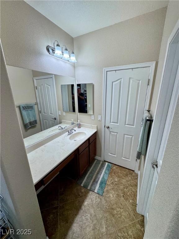 6614 Collingsworth St, Las Vegas, NV 89131 - bathroom with vanity, a textured ceiling, and tile patterned flooring