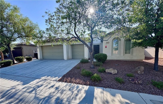 6614 Collingsworth St, Las Vegas, NV 89131 - view of front of property with concrete driveway, an attached garage, and stucco siding