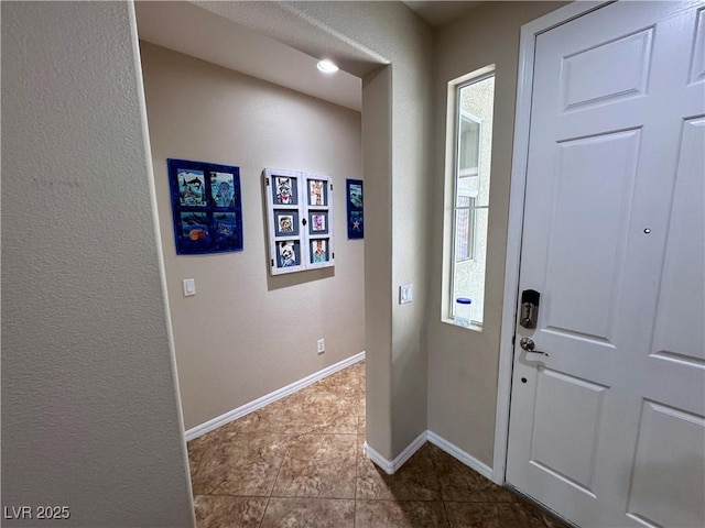 6614 Collingsworth St, Las Vegas, NV 89131 - entryway with dark tile patterned flooring and a textured wall