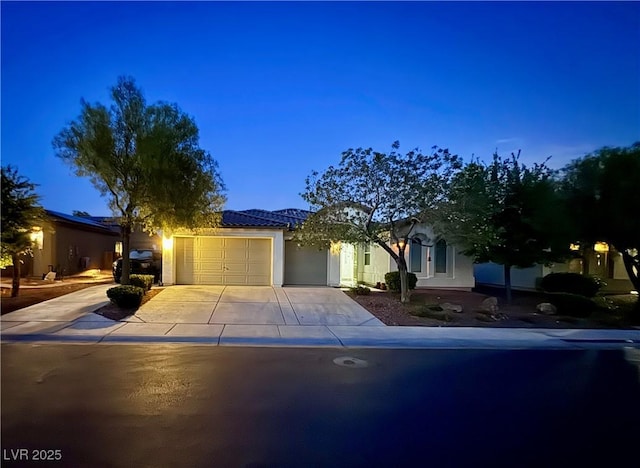 6614 Collingsworth St, Las Vegas, NV 89131 - obstructed view of property featuring an attached garage, driveway, and stucco siding